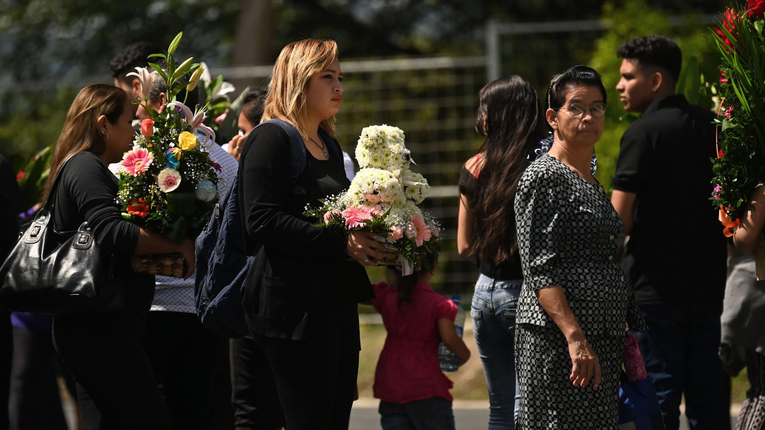 People attend the funeral of Salvadoran migrant Oscar Martinez and his almost two-year-old daughter Angie Valeria, who both drowned while trying to cross the Rio Grande from Mexico to the United States, at La Bermeja cemetery in San Salvador on July 1, 2019. (Credit: Marvin Recinos/AFP/Getty Images)