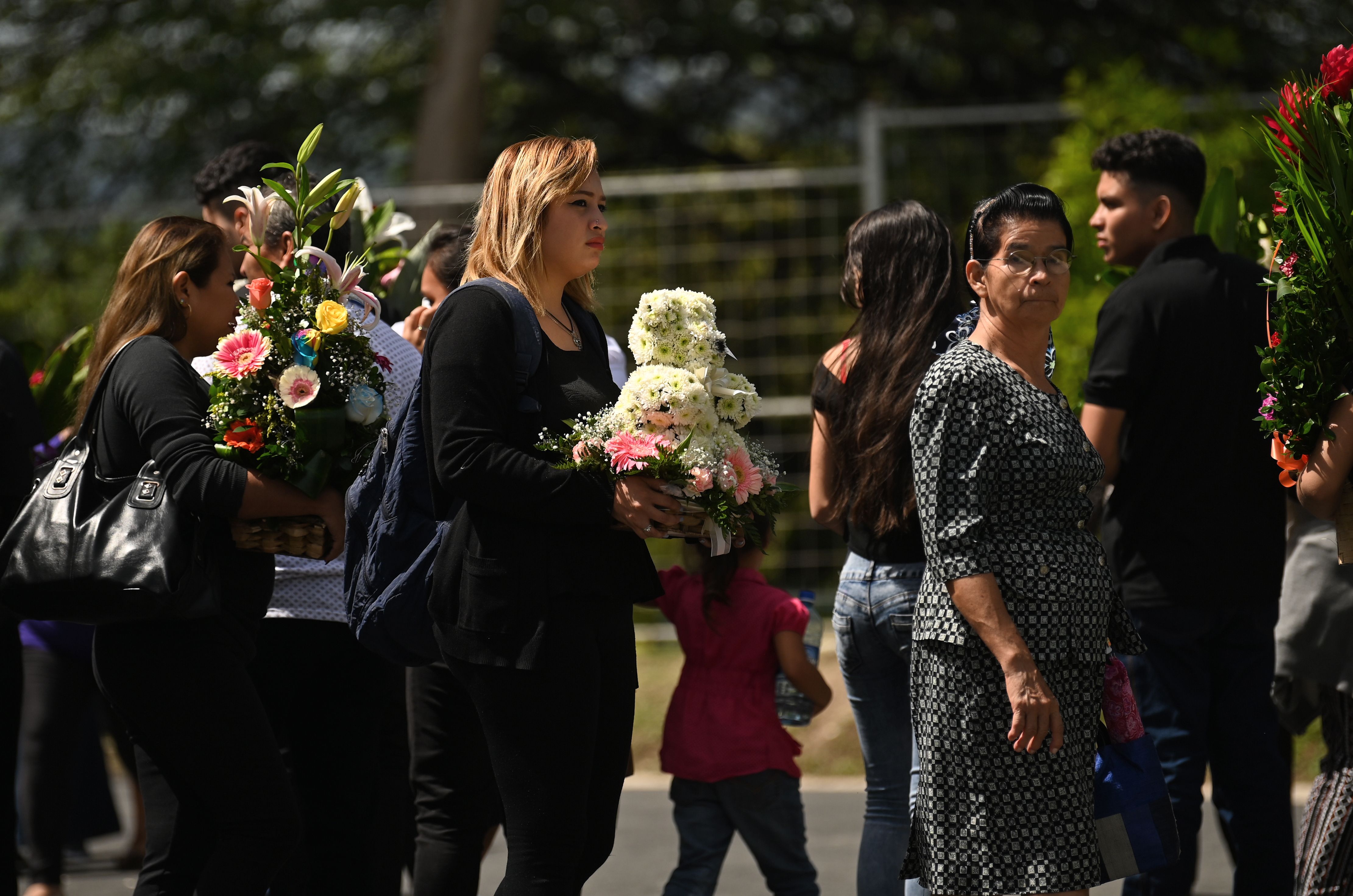 People attend the funeral of Salvadoran migrant Oscar Martinez and his almost two-year-old daughter Angie Valeria, who both drowned while trying to cross the Rio Grande from Mexico to the United States, at La Bermeja cemetery in San Salvador on July 1, 2019. (Credit: Marvin Recinos/AFP/Getty Images)