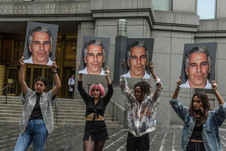 Protesters hold up photos of Jeffrey Epstein in front of the Federal courthouse on July 8, 2019 in New York City. (Credit: Stephanie Keith/Getty Images)