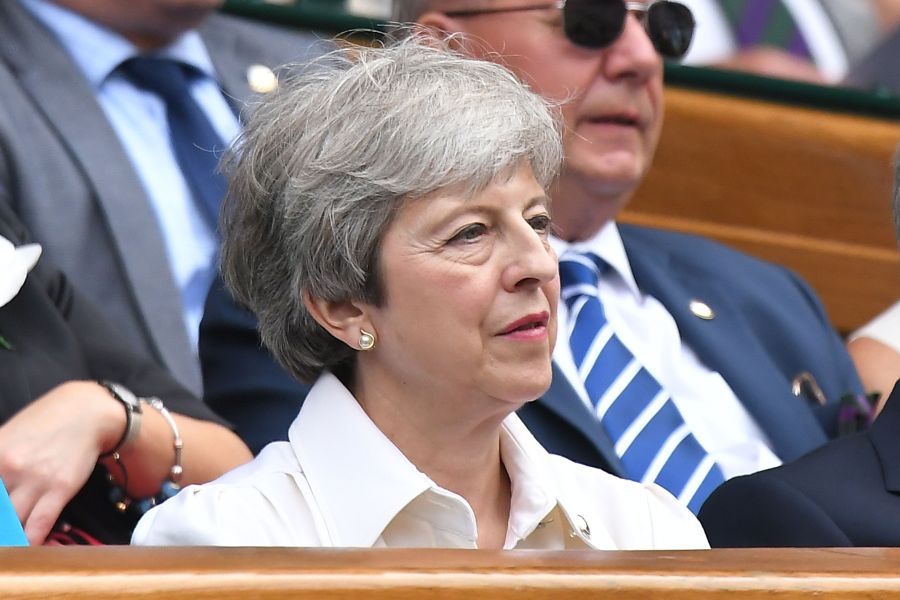 Britain's Prime Minister Theresa May sits in the Royal Box on Centre Court to watch Romania's Simona Halep playing U.S. player Serena Williams during their women's singles final on day twelve of the 2019 Wimbledon Championships at The All England Lawn Tennis Club in Wimbledon, southwest London, on July 13, 2019. (Credit: BEN STANSALL/AFP/Getty Images)