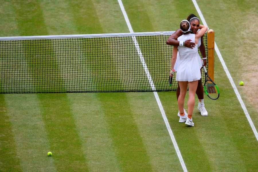 Romania's Simona Halep hugs U.S. player Serena Williams after beating her during their women's singles final on day 12 of the 2019 Wimbledon Championships at The All England Lawn Tennis Club in Wimbledon, southwest London, on July 13, 2019. (Credit: TOBY MELVILLE/AFP/Getty Images)