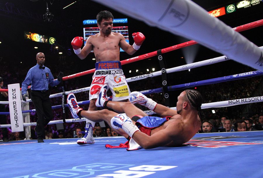 Manny Pacquiao sends Keith Thurman to the mat during the first round of their WBA super world welterweight title fight at the MGM Grand Garden Arena on July 20, 2019 in Las Vegas, Nevada. (Credit: JOHN GURZINSKI/AFP/Getty Images)