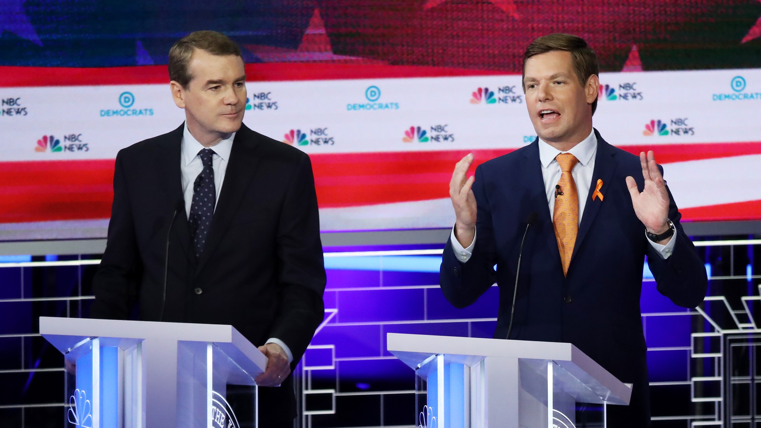 Rep. Eric Swallwell, D-California, speaks as Sen. Michael Bennet, D-Colorado, looks on during the second night of the first Democratic presidential debate on June 27, 2019 in Miami. (Credit: Drew Angerer/Getty Images)