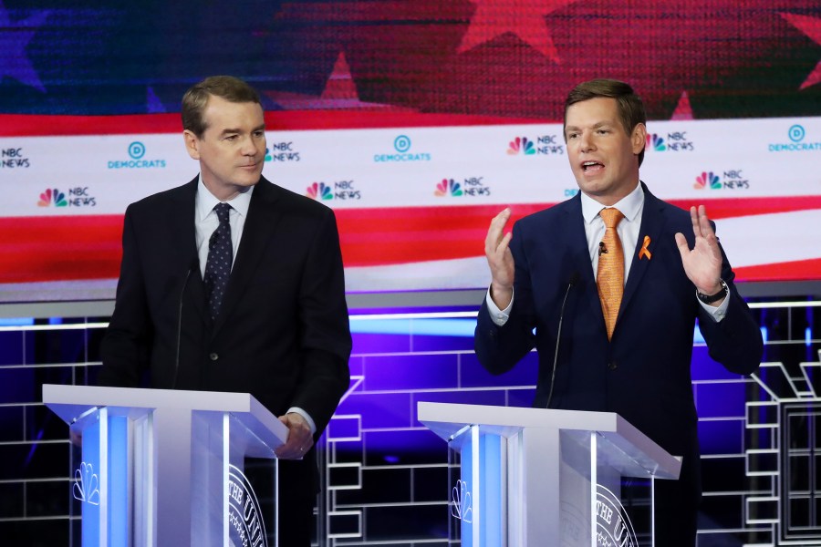 Rep. Eric Swallwell, D-California, speaks as Sen. Michael Bennet, D-Colorado, looks on during the second night of the first Democratic presidential debate on June 27, 2019 in Miami. (Credit: Drew Angerer/Getty Images)