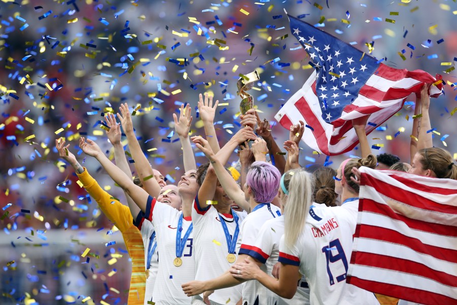 The U.S. women's national team celebrates with the trophy following victory in the 2019 FIFA Women's World Cup France Final match against the Netherlands at Stade de Lyon on July 7, 2019 in Lyon, France. (Credit: Alex Grimm/Getty Images)