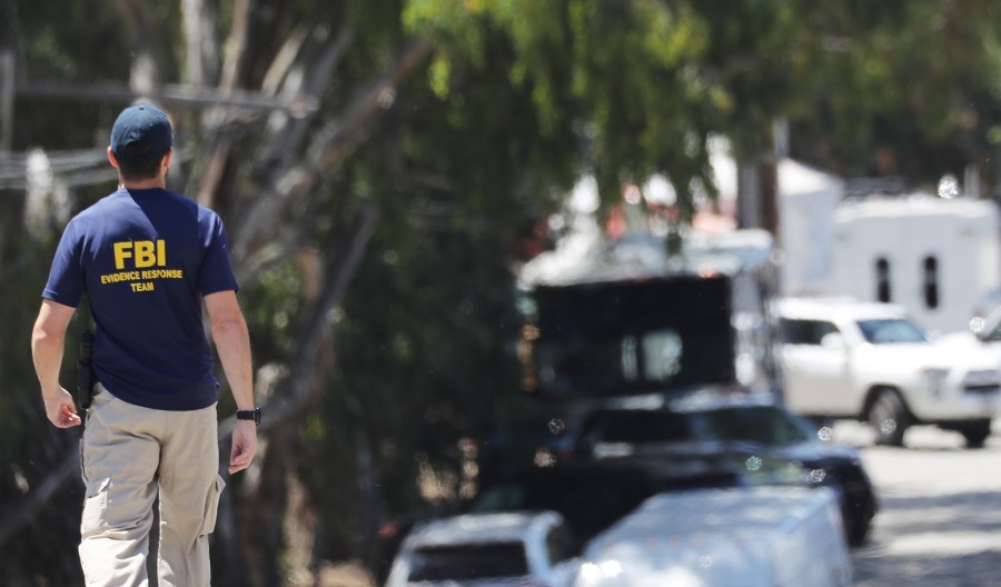 An FBI agent walks toward the site of the Gilroy Garlic Festival after a mass shooting took place there yesterday on July 29, 2019 in Gilroy, California. (Credit: Mario Tama/Getty Images)