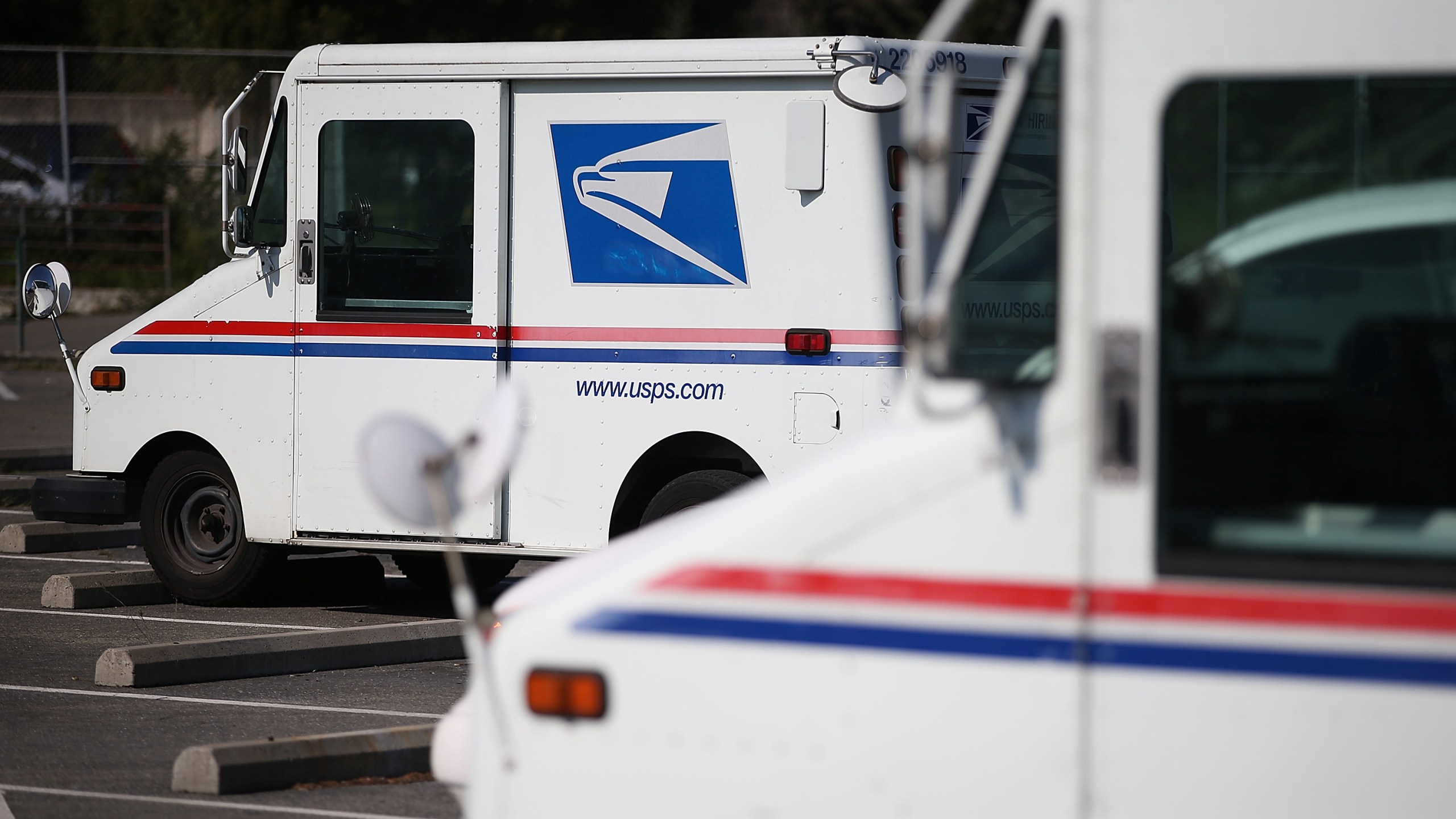 U.S. Postal Service mail trucks sit in a parking lot at a distribution center in San Francisco on Feb. 18, 2015. (Justin Sullivan / Getty Images)