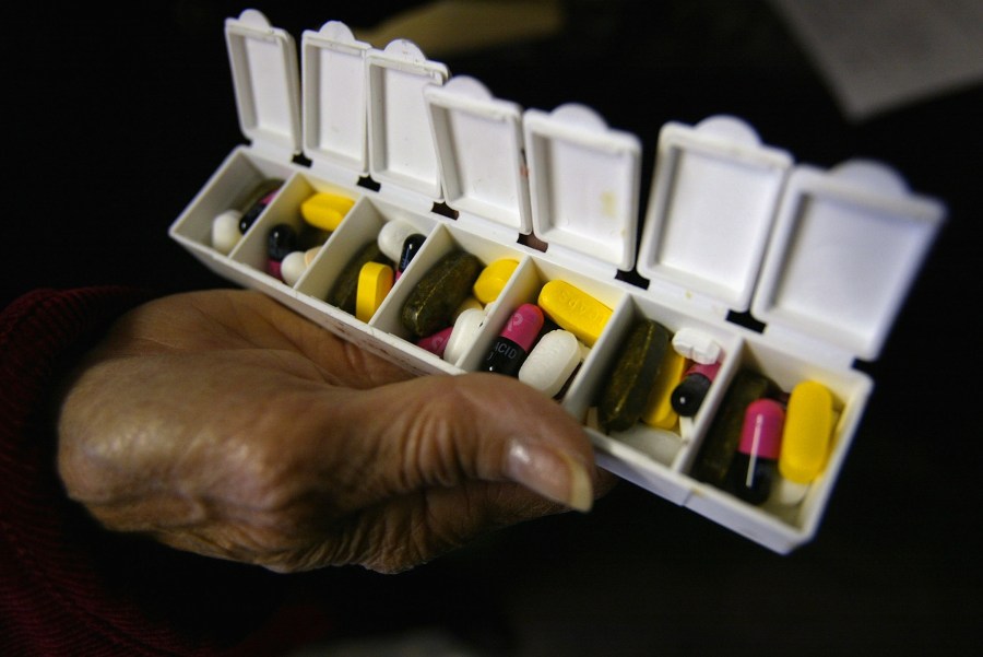 Carole Jaquez displays a box of pills for her asthma and high blood pressure condition purchased in Canada at a 58.9% savings on Oct. 12, 2004 in New York City. (Credit: Spencer Platt/Getty Images)