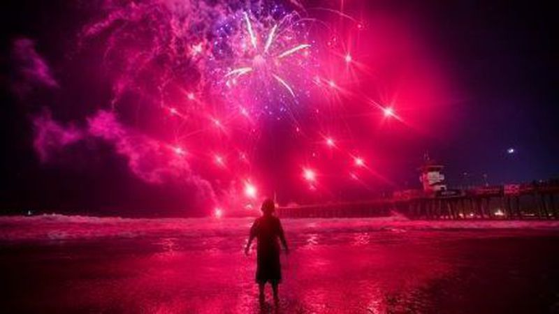 A child watches Fourth of July fireworks in Huntington Beach on July 4, 2019. (Allen J. Schaben/Los Angeles Times)