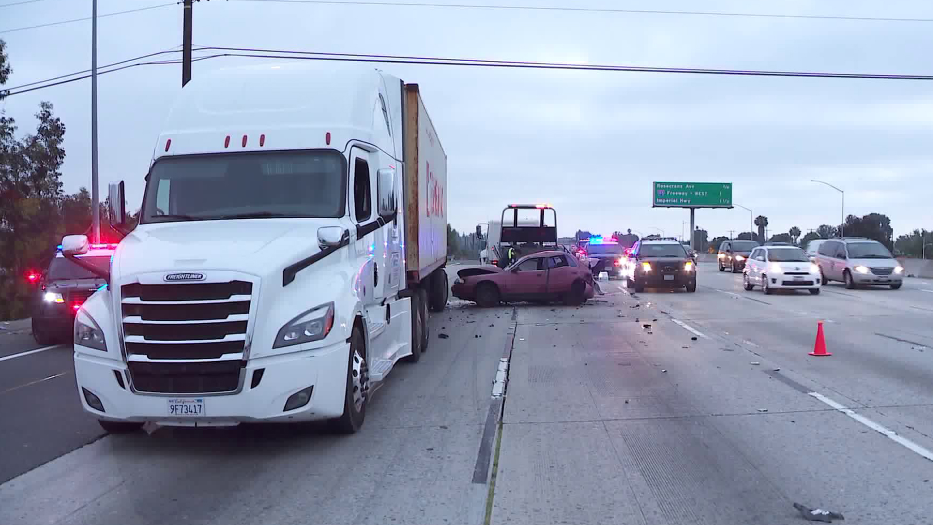 A big rig and a sedan sit on the southbound 605 Freeway in Norwalk on July 2, 2019. (Credit: KTLA)