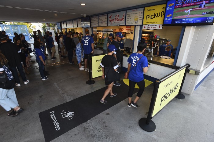 Fans use a designated Postmates pick-up line at Dodger Stadium in this photo provided by the app company.