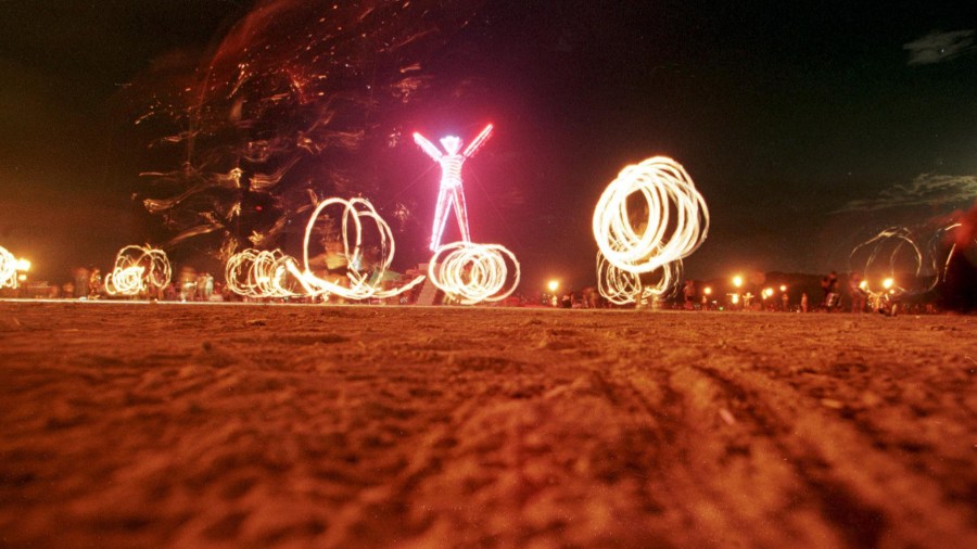 Dancers at the "Burning Man" festival create patterns with fireworks in the Black Rock Desert of Nevada just prior to burning a five-story, neon-lit effigy of a man on the last night of the week-long festival in September 2006. (Credit: MIKE NELSON/AFP/Getty Images)