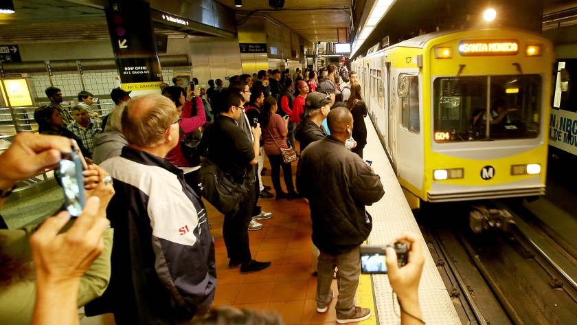 A crowd waits as an Expo Line train pulls in at 7th Street/Metro Center downtown in 2016.(Credit: Luis Sinco / Los Angeles Times)