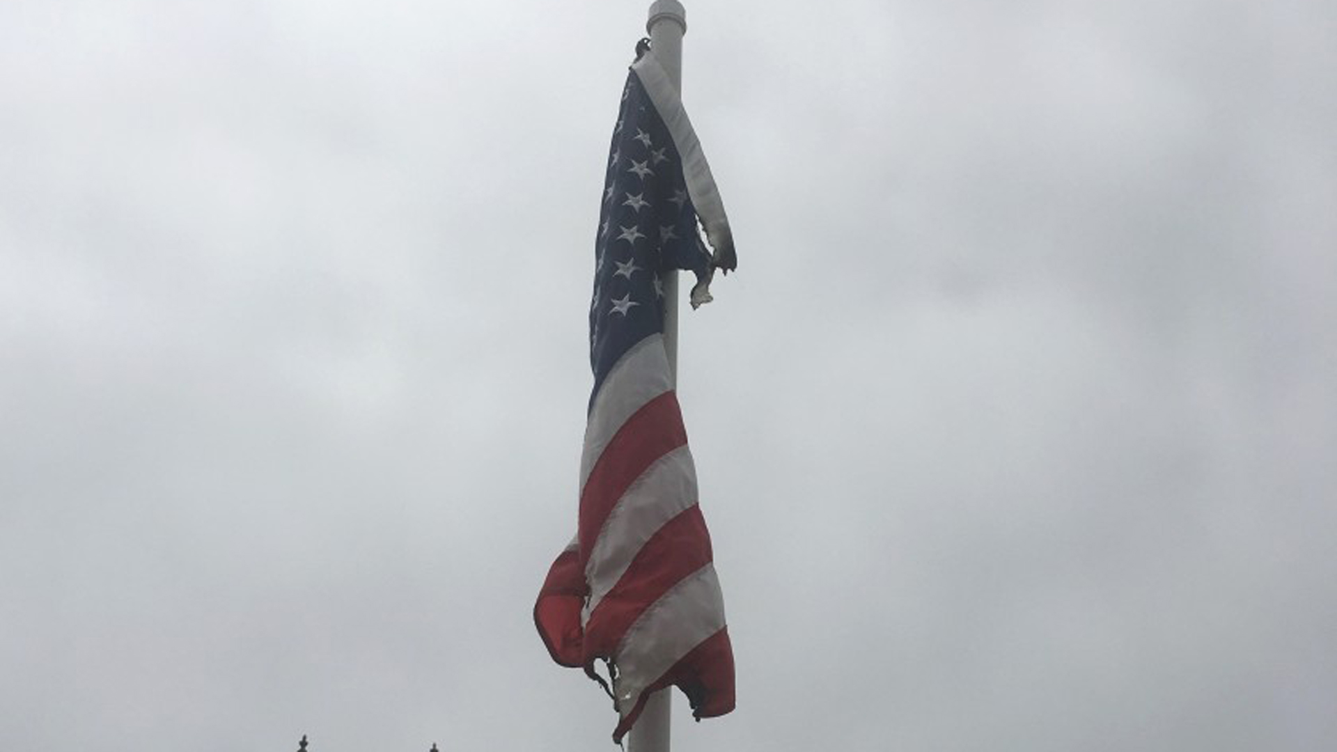 A burned American flag hanging at the Balboa Island bridge in Newport Beach. (Credit: Jack Callahan/ Balboa Island Improvement Assn. via Los Angeles Times)