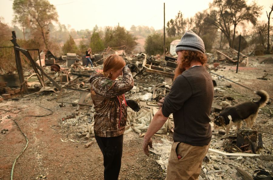 Kimberly Spainhower and her husband Ryan Spainhower weep while searching through the ashes of their burned home in Paradise, California on Nov. 18, 2018. (Credit: JOSH EDELSON/AFP/Getty Images)