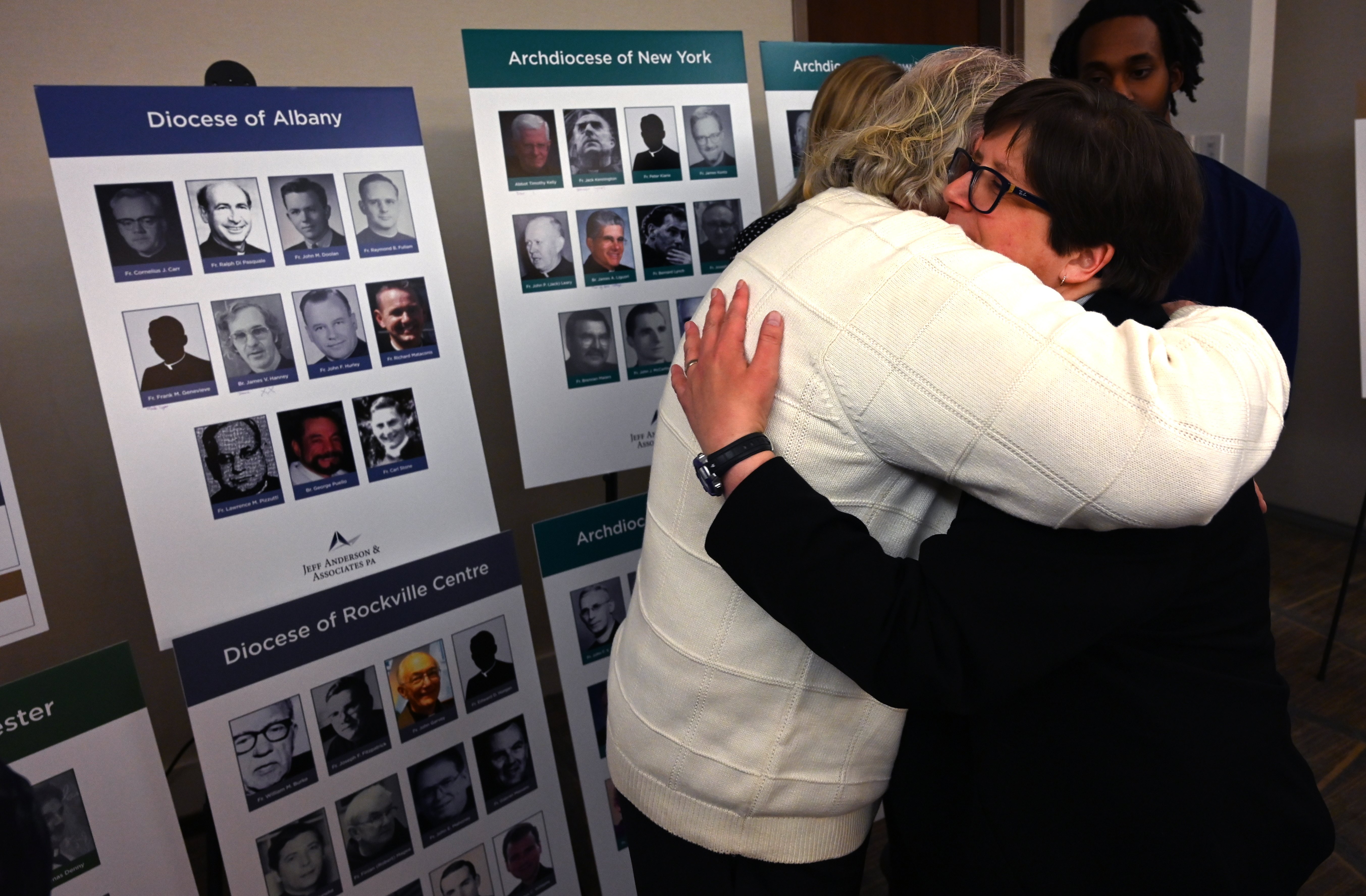 Survivor Bridget Lyons hugs a man after a press conference in New York February 14, 2019, to announce the filing of a lawsuit against the Catholic Church. (Credit: TIMOTHY A. CLARY/AFP/Getty Images)