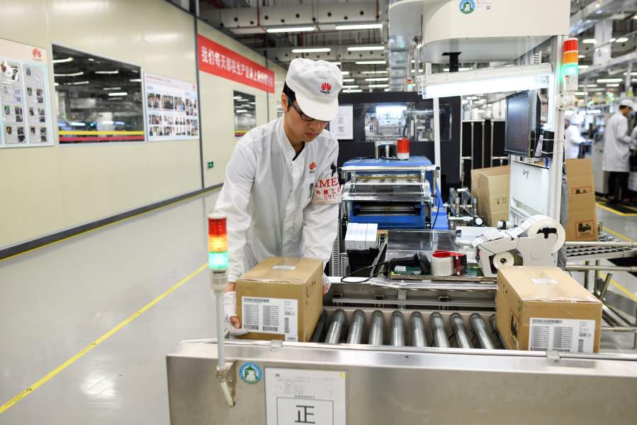 An employee works on a mobile phone production line at a Huawei production base during a media tour in Dongguan, China's Guangdong province on March 6, 2019. (Credit: WANG ZHAO/AFP/Getty Images)