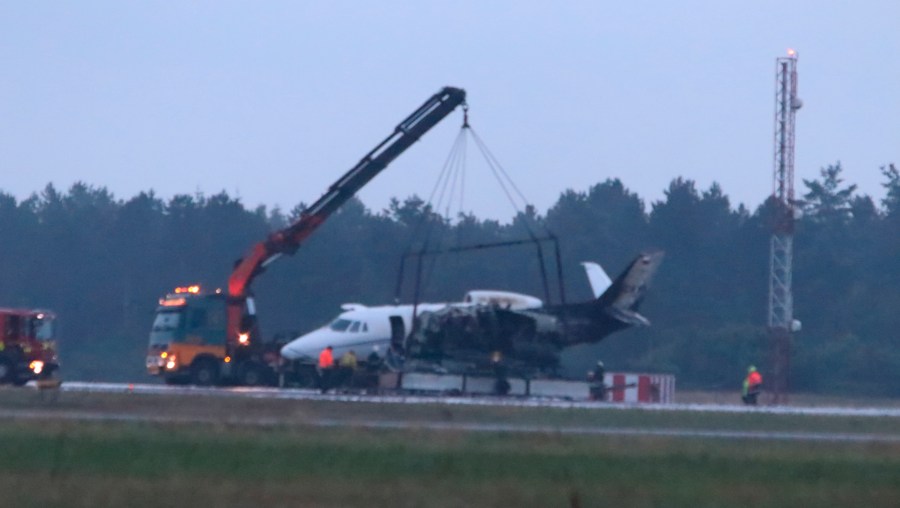 Emergency services are seen next to a Cessna 560XL that caught fire upon landing at Aarhus Airport in Tirstrup in the early hours of Aug. 6, 2019. (Credit: OEXENHOLT FOTO/AFP/Getty Images)