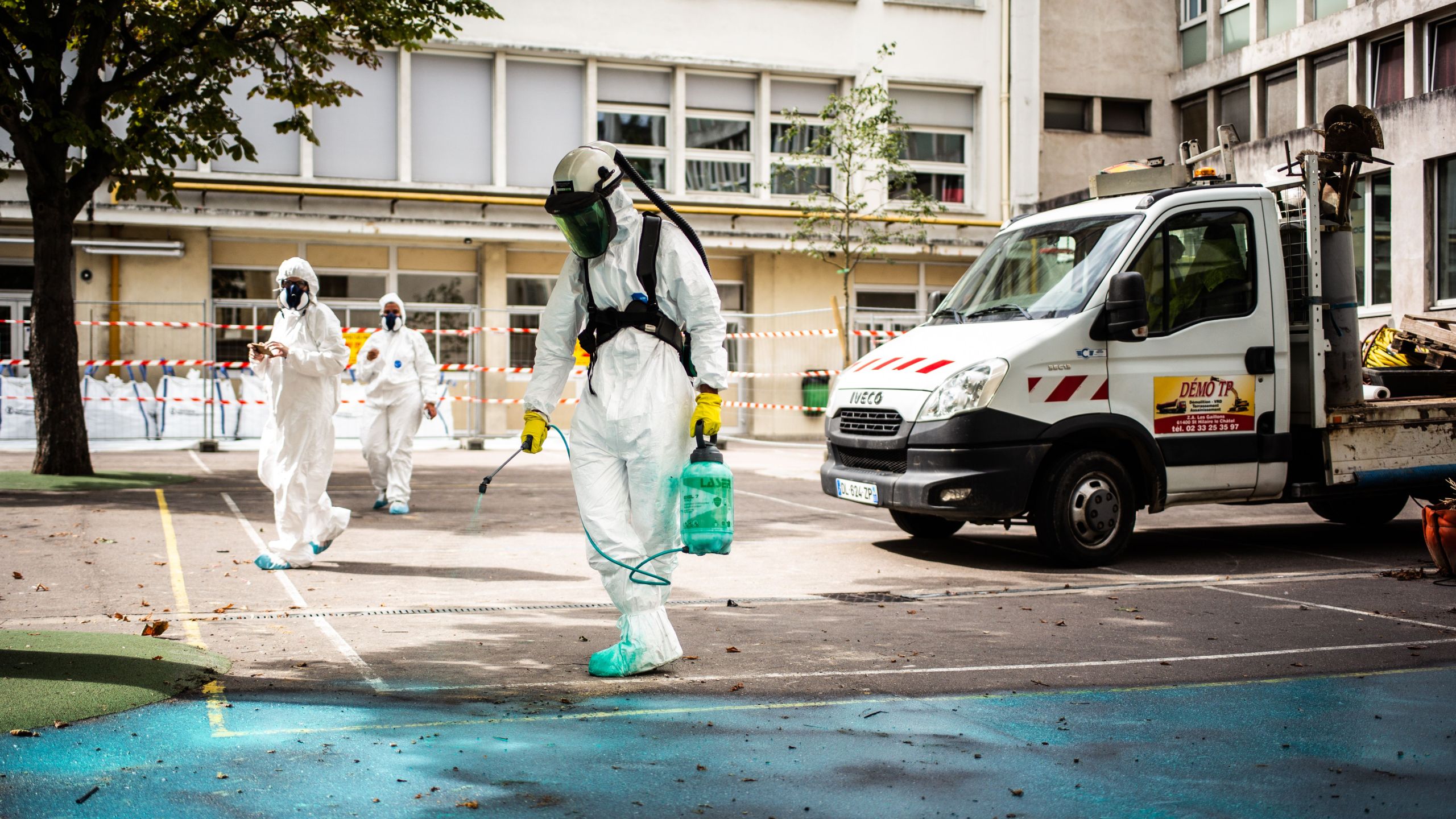 A worker sprays a gel on the ground to absorb lead as he takes part in a clean-up operation at Saint Benoit school near Notre-Dame cathedral in Paris during a decontamination work on Aug. 8, 2019. (Credit: MARTIN BUREAU/AFP/Getty Images)