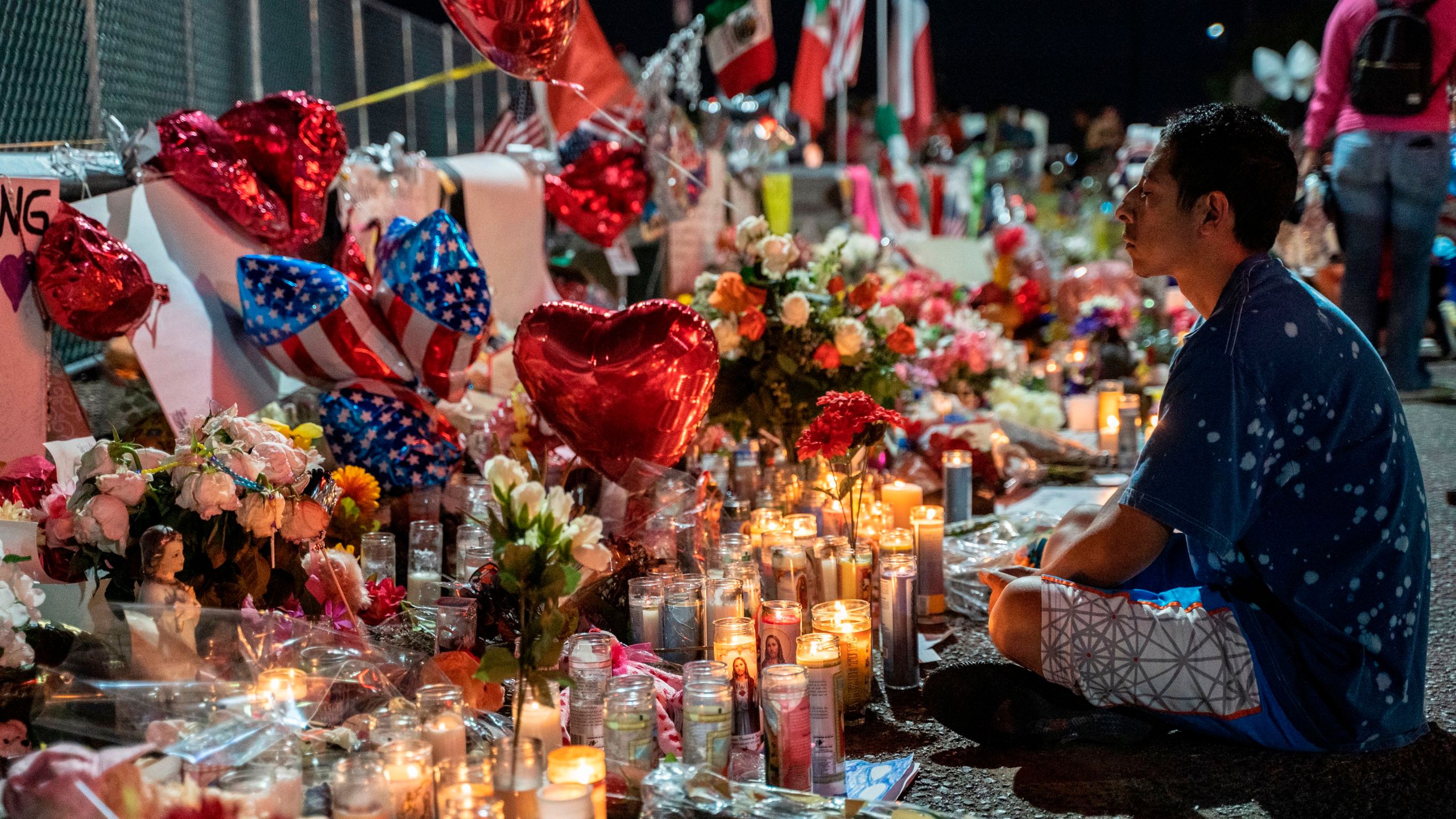 Abel Valenzuela, an El Paso local, meditates in front of the makeshift memorial for shooting victims at the Cielo Vista Mall Walmart in El Paso, Texas, on Aug. 8, 2019. (Credit: Paul Ratje / AFP / Getty Images)