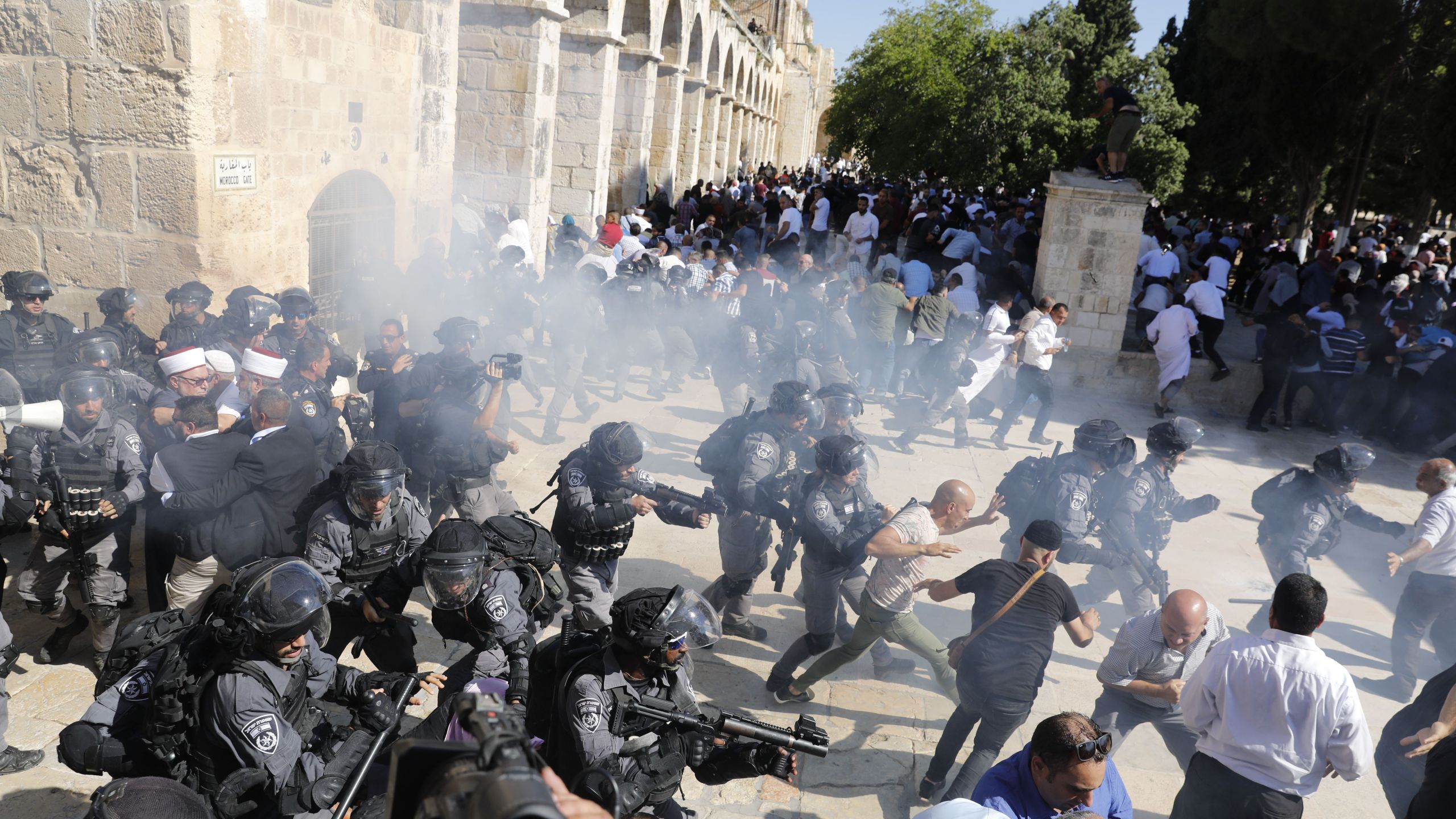 Israeli security forces fire sound grenades inside the Al-Aqsa Mosque compound in the Old City of Jerusalem on August 11, 2019, as clashes broke out during the overlapping Jewish and Muslim holidays of Eid al-Adha and the Tisha B'av holdiay inside the hisotric compound which is considered the third-holiest site in Islam and the most sacred for Jews, who revere it as the location of the two biblical-era temples. (Credit: AHMAD GHARABLI/AFP/Getty Images)