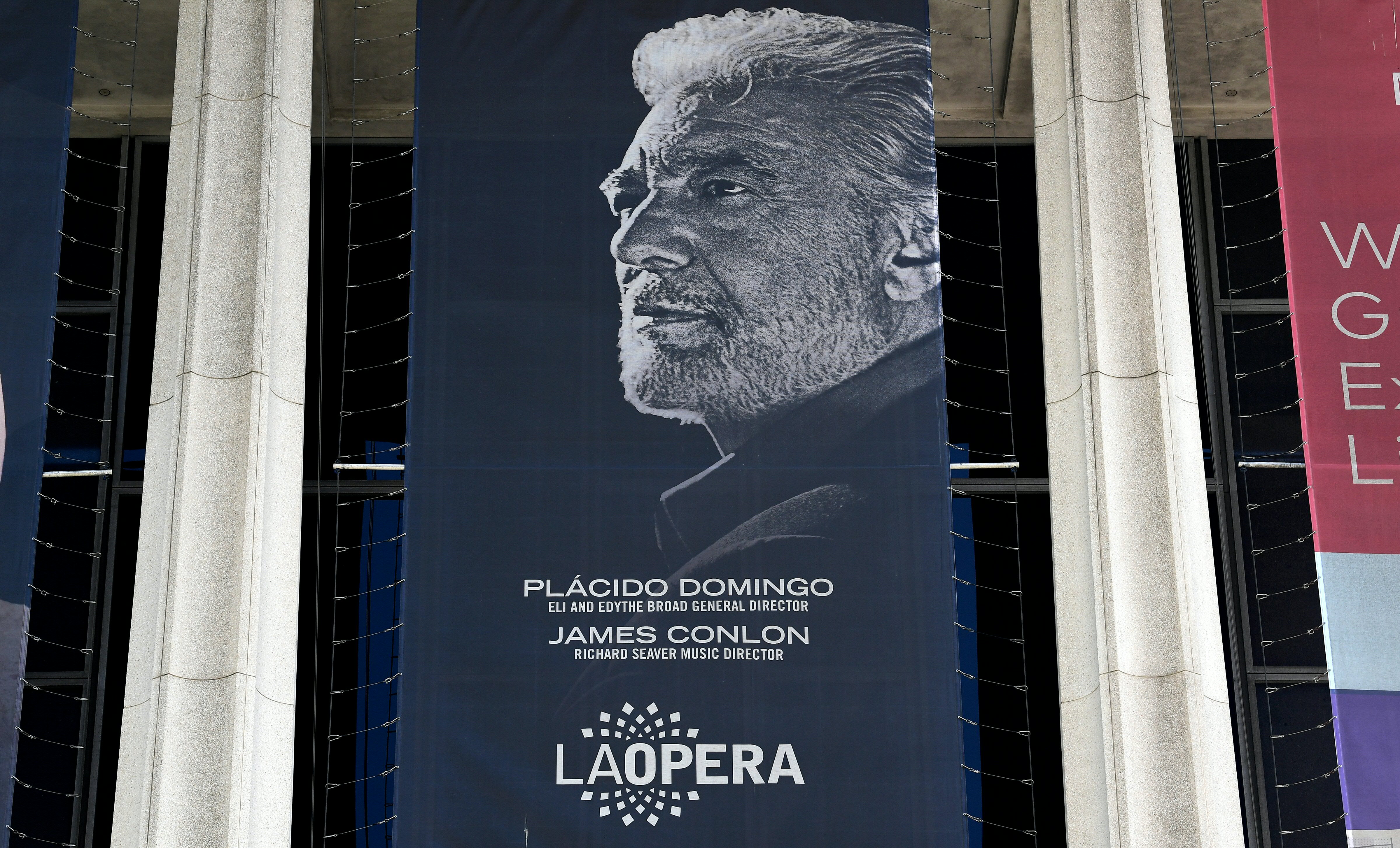 A banner showing the Los Angeles Opera's general director, Spanish tenor Placido Domingo, hangs from the Dorothy Chandler Pavilion on Aug. 13, 2019. (Credit: FREDERIC J. BROWN/AFP/Getty Images)