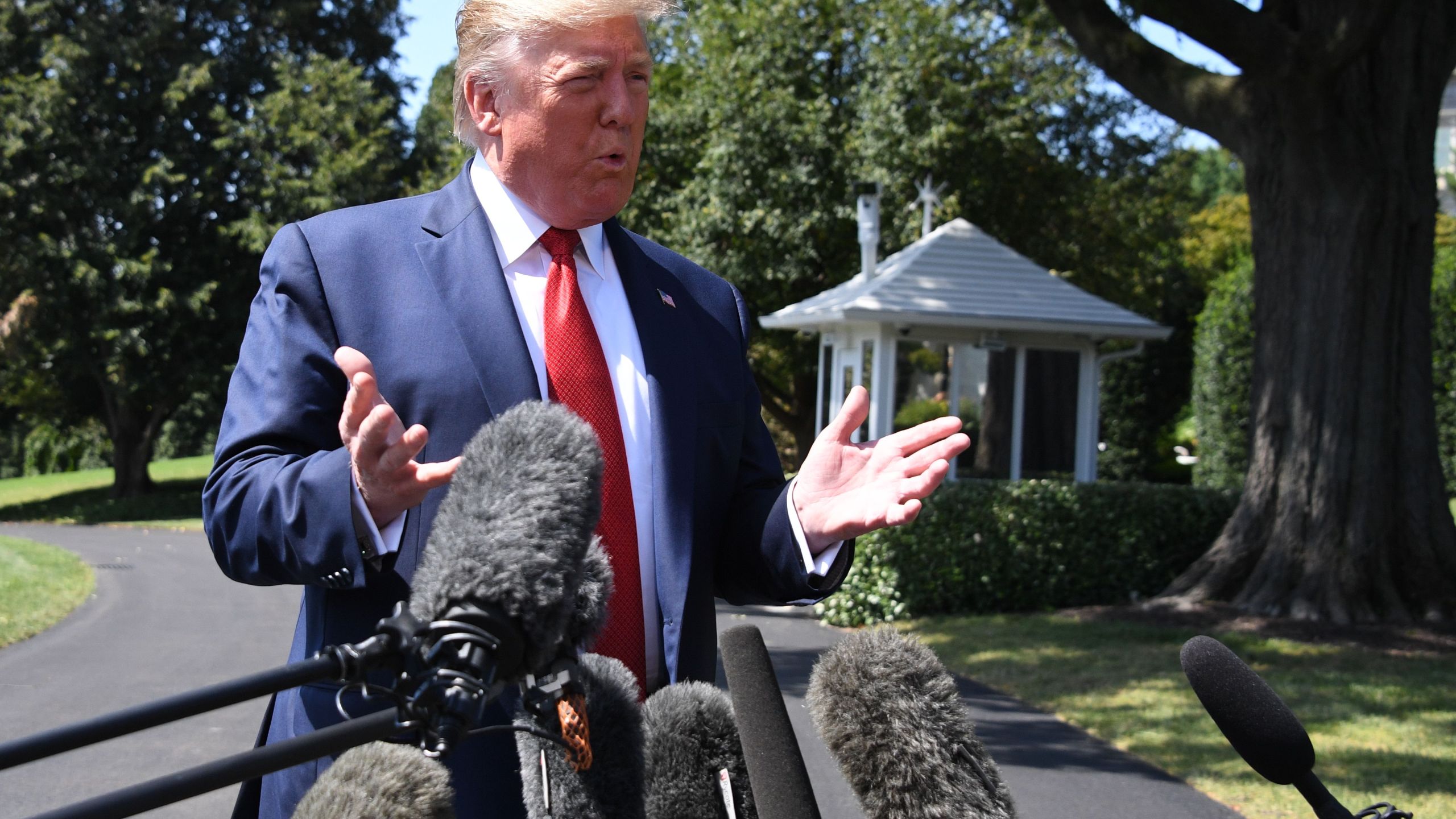 US President Donald Trump speaks to the media as he departs the White House in Washington, DC, on August 21, 2019. (Credit: JIM WATSON/AFP/Getty Images)