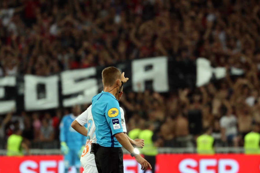 French referee Clement Turpin gestures as he halts the game after supporters shouted homophobic songs and brandished banners during the football match between OGC Nice and Olympique de Marseille on August 28, 2019 in southeastern France. (Credit: VALERY HACHE/AFP/Getty Images)