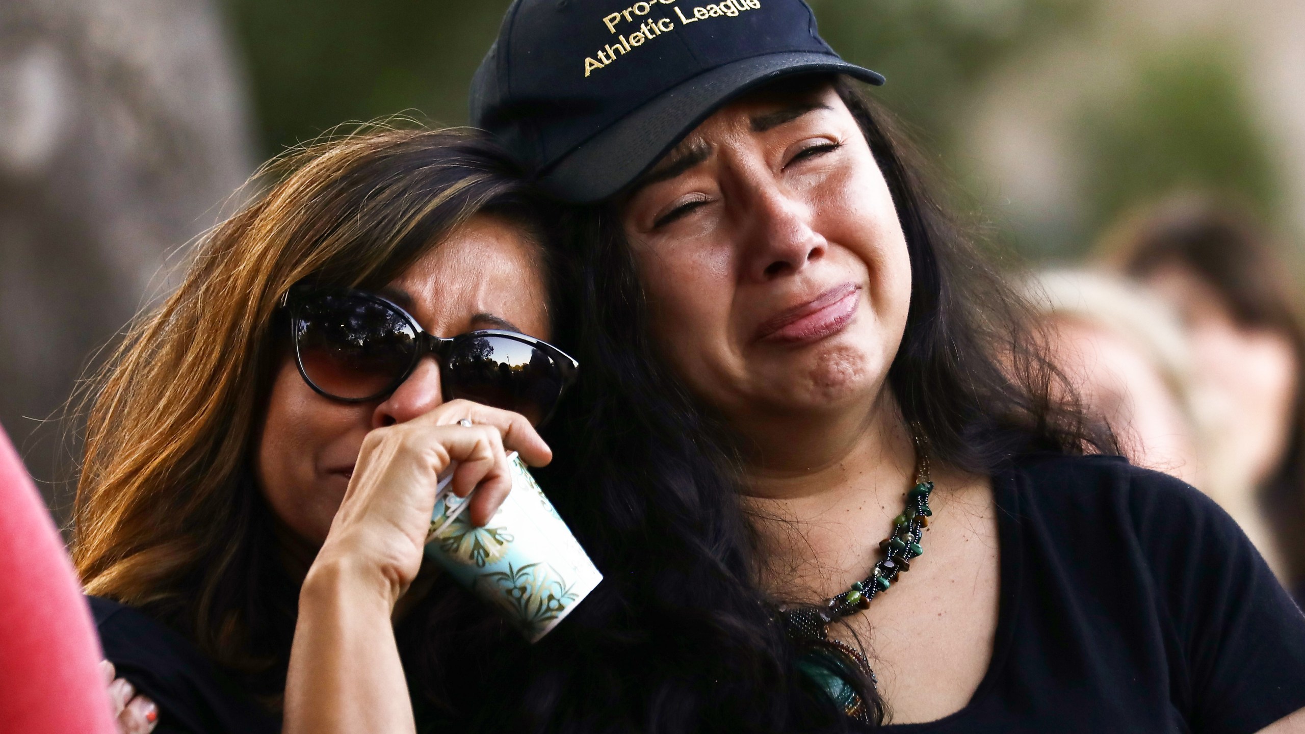 People embrace at a vigil for victims of the mass shooting at the Gilroy Garlic Festival on July 29, 2019 in Gilroy. (Credit: Mario Tama/Getty Images)