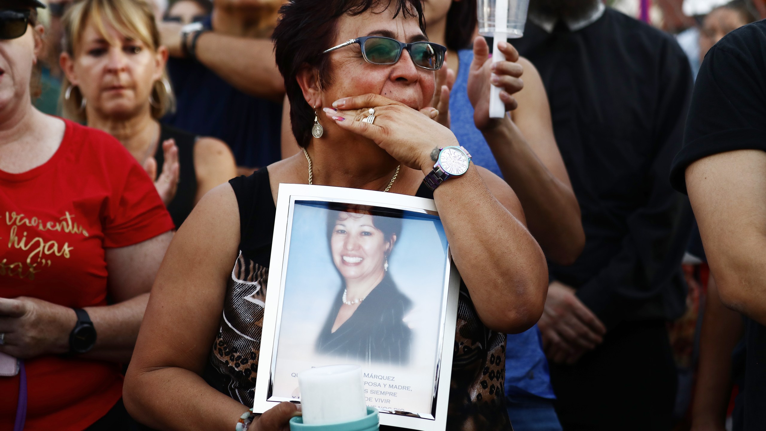 Lupe Lopez carries a photo of Elsa Mendoza Marquez, a Mexican schoolteacher from across the border in Ciudad Juarez who was killed in the shooting, during an interfaith vigil for victims of a mass shooting, which left at least 20 people dead, on Aug. 4, 2019 in El Paso, Texas. (Credit: Mario Tama/Getty Images)