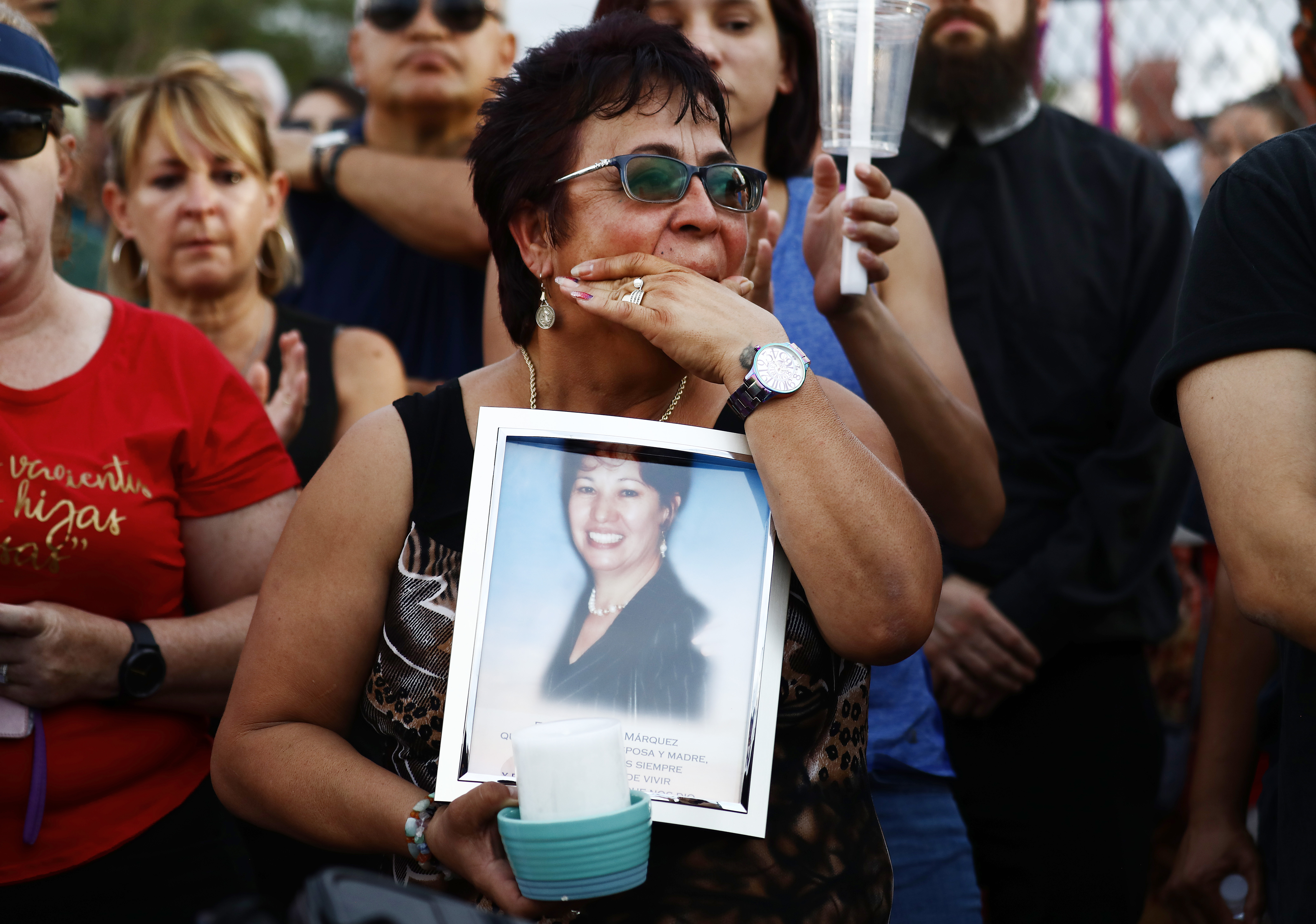 Lupe Lopez carries a photo of Elsa Mendoza Marquez, a Mexican schoolteacher from across the border in Ciudad Juarez who was killed in the shooting, during an interfaith vigil for victims of a mass shooting, which left at least 20 people dead, on Aug. 4, 2019 in El Paso, Texas. (Credit: Mario Tama/Getty Images)