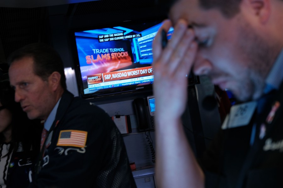 Traders work on the floor of the New York Stock Exchange on Aug. 5, 2019. (Credit: Spencer Platt / Getty Images)