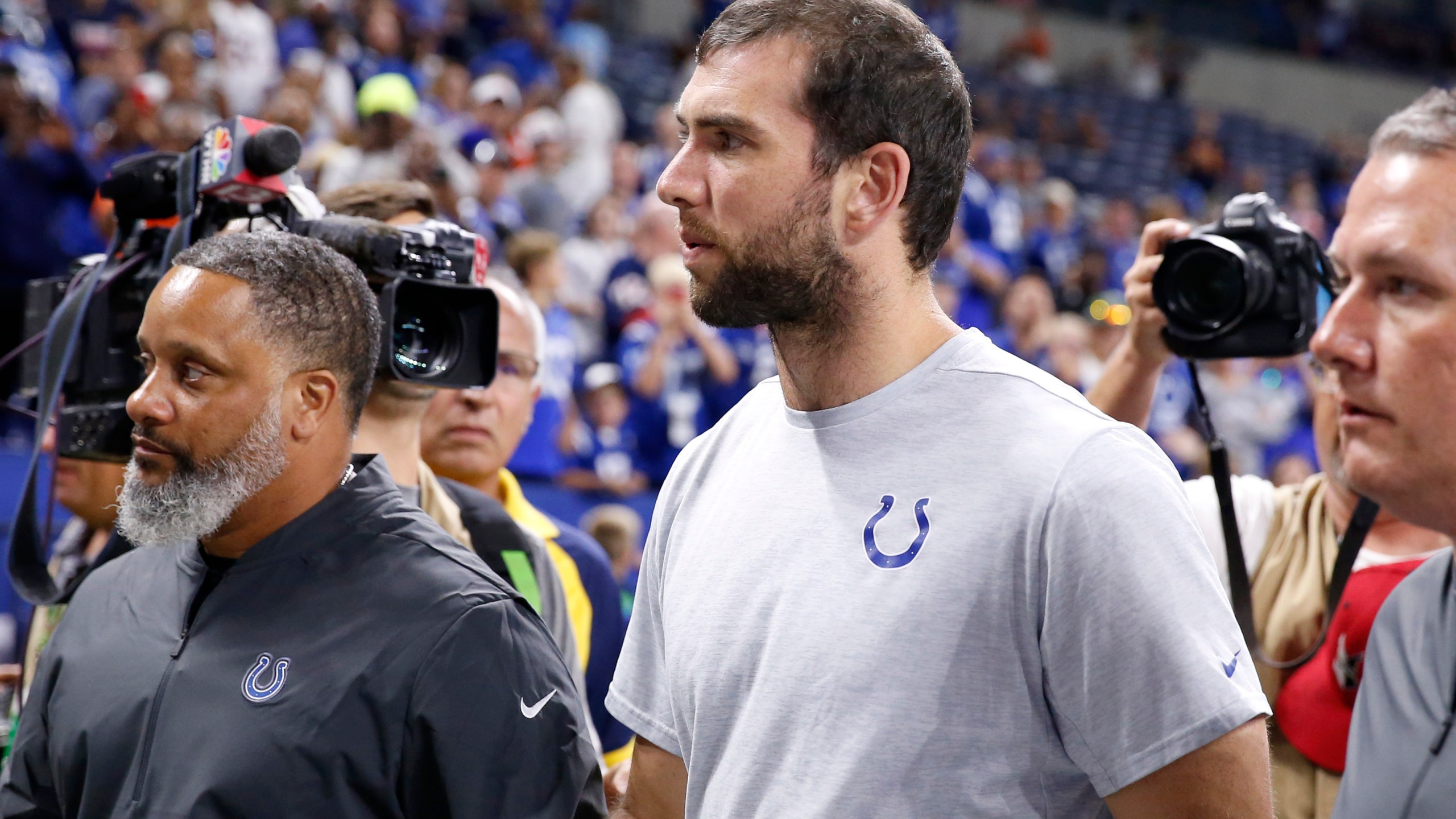 Andrew Luck walks off the field after the Indianapolis Colts pre-season game against the Chicago Bears after it was reported that he would be retiring at Lucas Oil Stadium on Aug. 24, 2019 in Indianapolis, Indiana. (Credit: Justin Casterline/Getty Images)