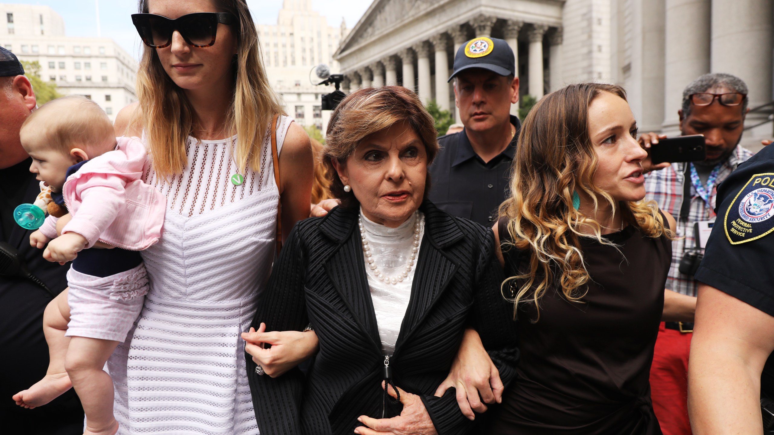 Attorney Gloria Allred, center, leaves a New York City courthouse on Aug. 27, 2019, with two women, a woman who did not wish to be identified, left, and Teala Davies, right, who have accused Jeffrey Epstein of sexually assaulting them. (Credit: Spencer Platt / Getty Images)