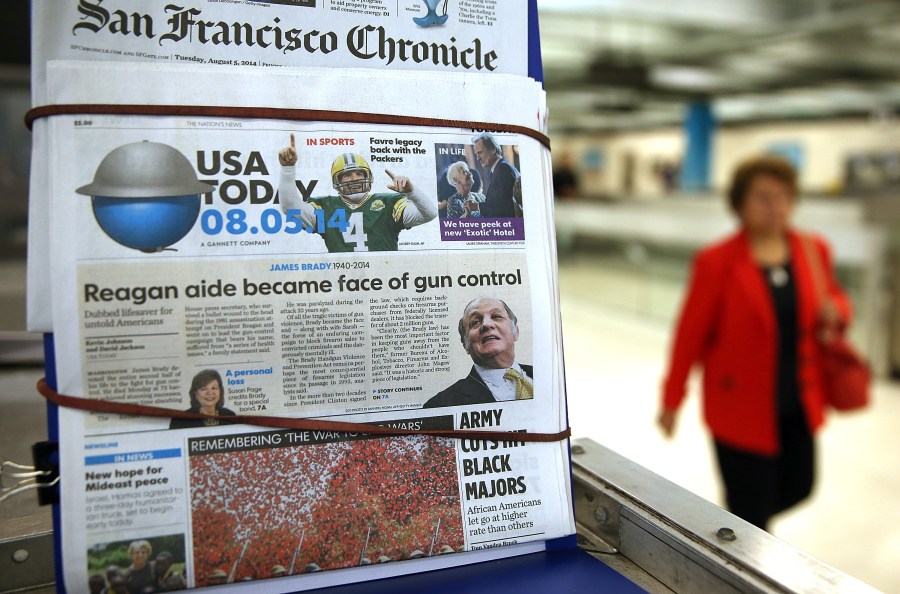 A copy of USA Today is displayed at a newsstand on Aug. 5, 2014, in San Francisco. USA Today owner Gannett Co. announced plans at the time to spin off its publishing business and create two publicly traded companies in order to separate its publishing division from its broadcasting and digital businesses. (Credit: Justin Sullivan/Getty Images)