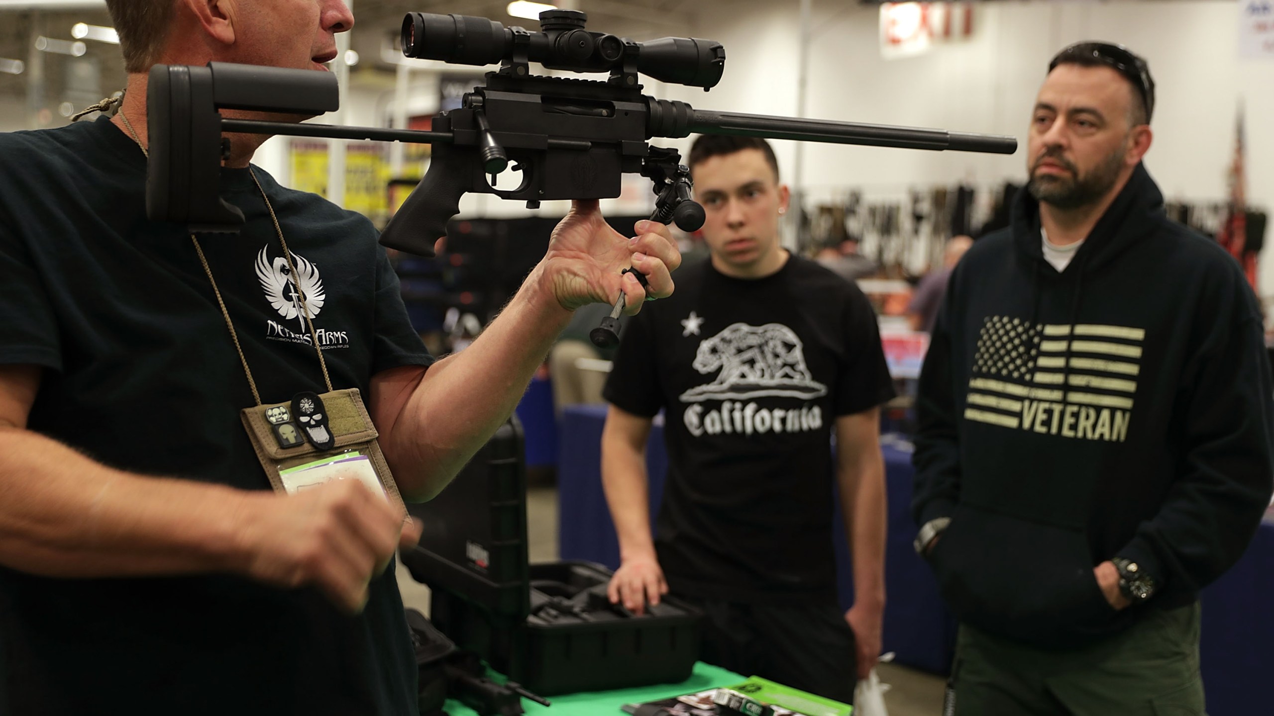 A gun seller demonstrates a firearm to potential buyers during the Nation's Gun Show on Nov. 18, 2016, at Dulles Expo Center in Chantilly, Virg. (Credit: Alex Wong/Getty Images)