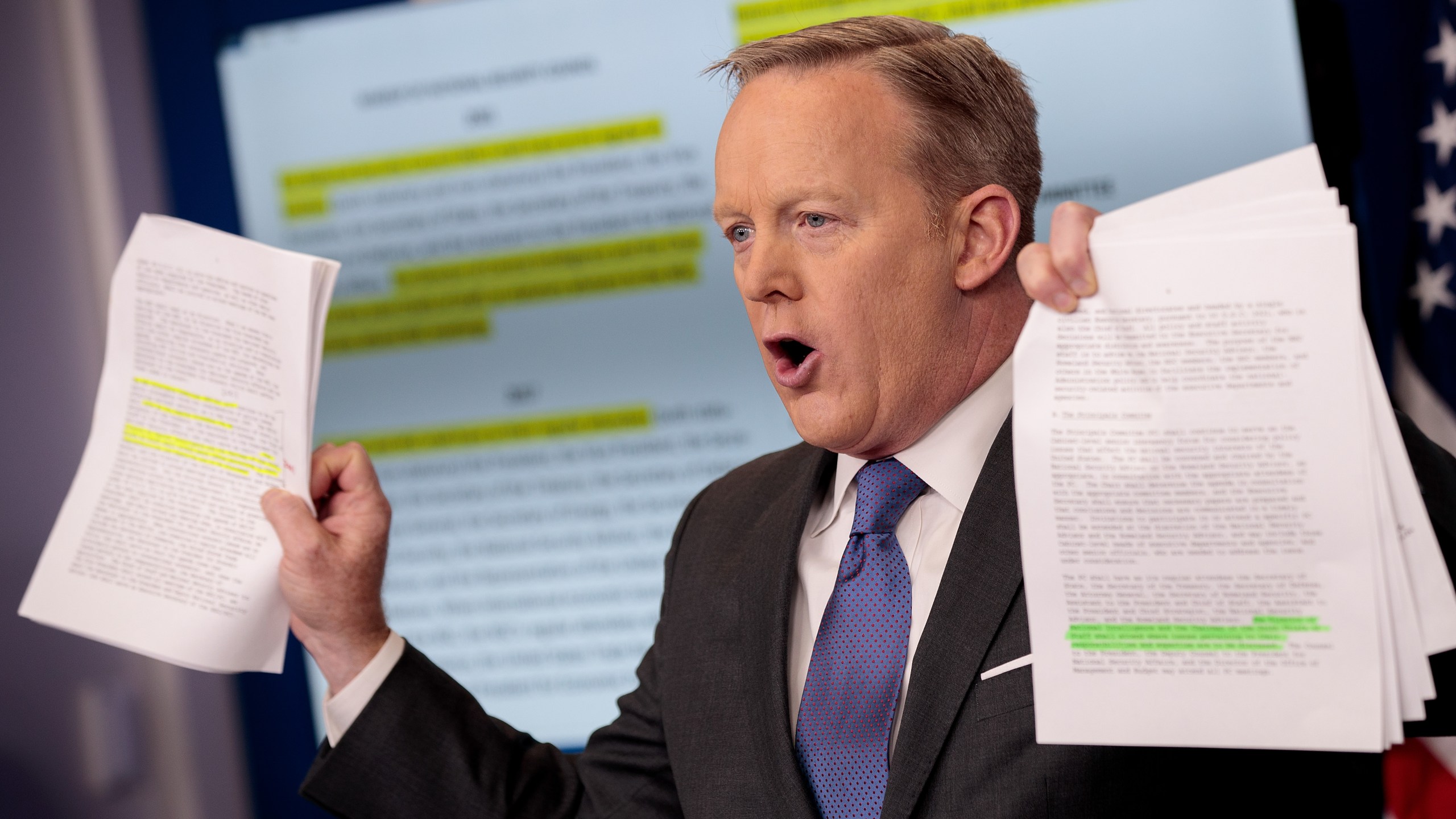 Sean Spicer holds up paperwork highlighting and comparing language about the National Security Council from the Trump administration and previous administrations during the daily press briefing at the White House, on Jan. 30, 2017 in Washington, D.C. (Credit: Drew Angerer/Getty Images)