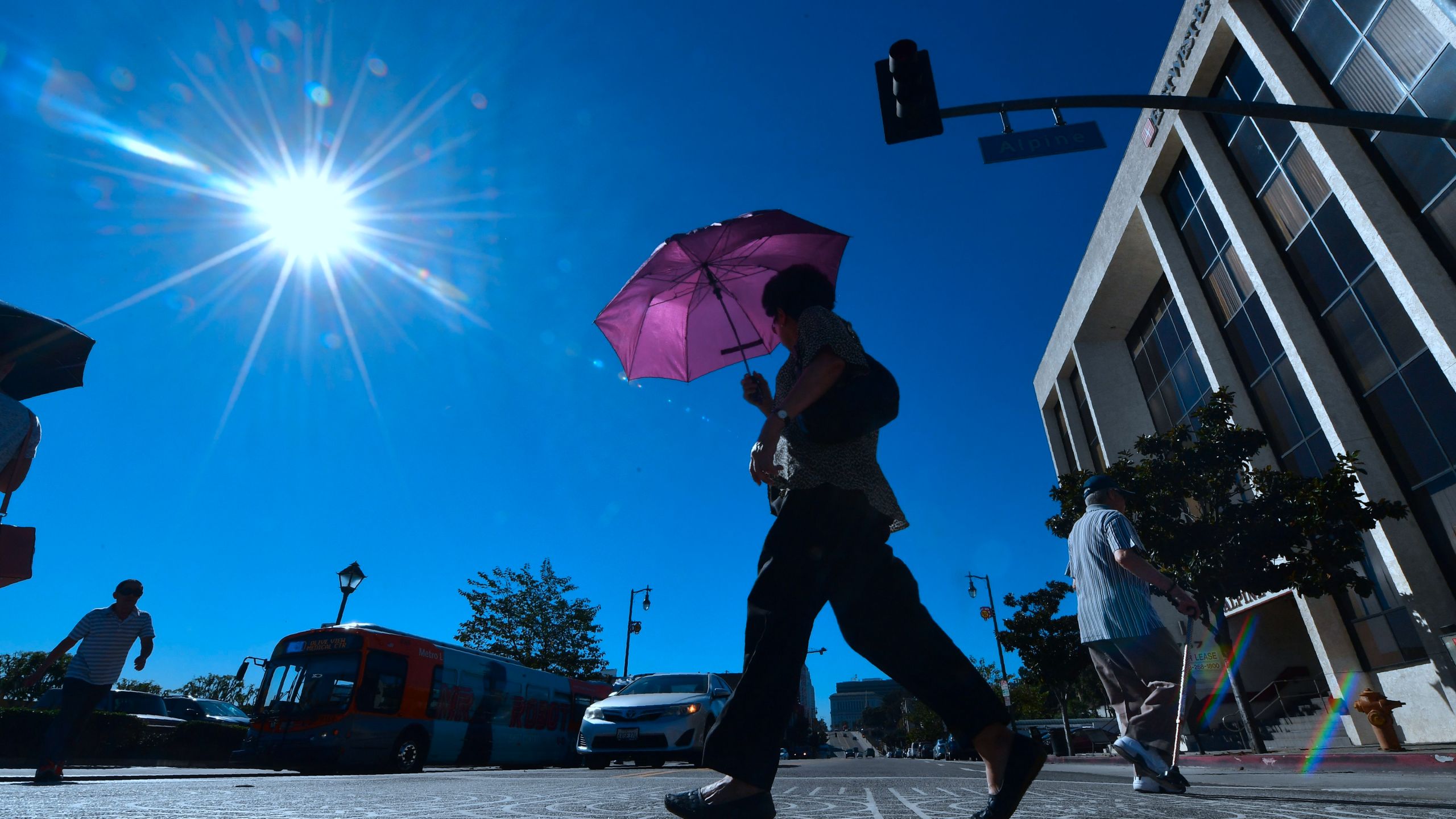 A pedestrian uses an umbrella on a hot sunny morning in Los Angeles Oct. 24, 2017, amid a late season heatwave hitting Southern California. (FREDERIC J. BROWN/AFP/Getty Images)