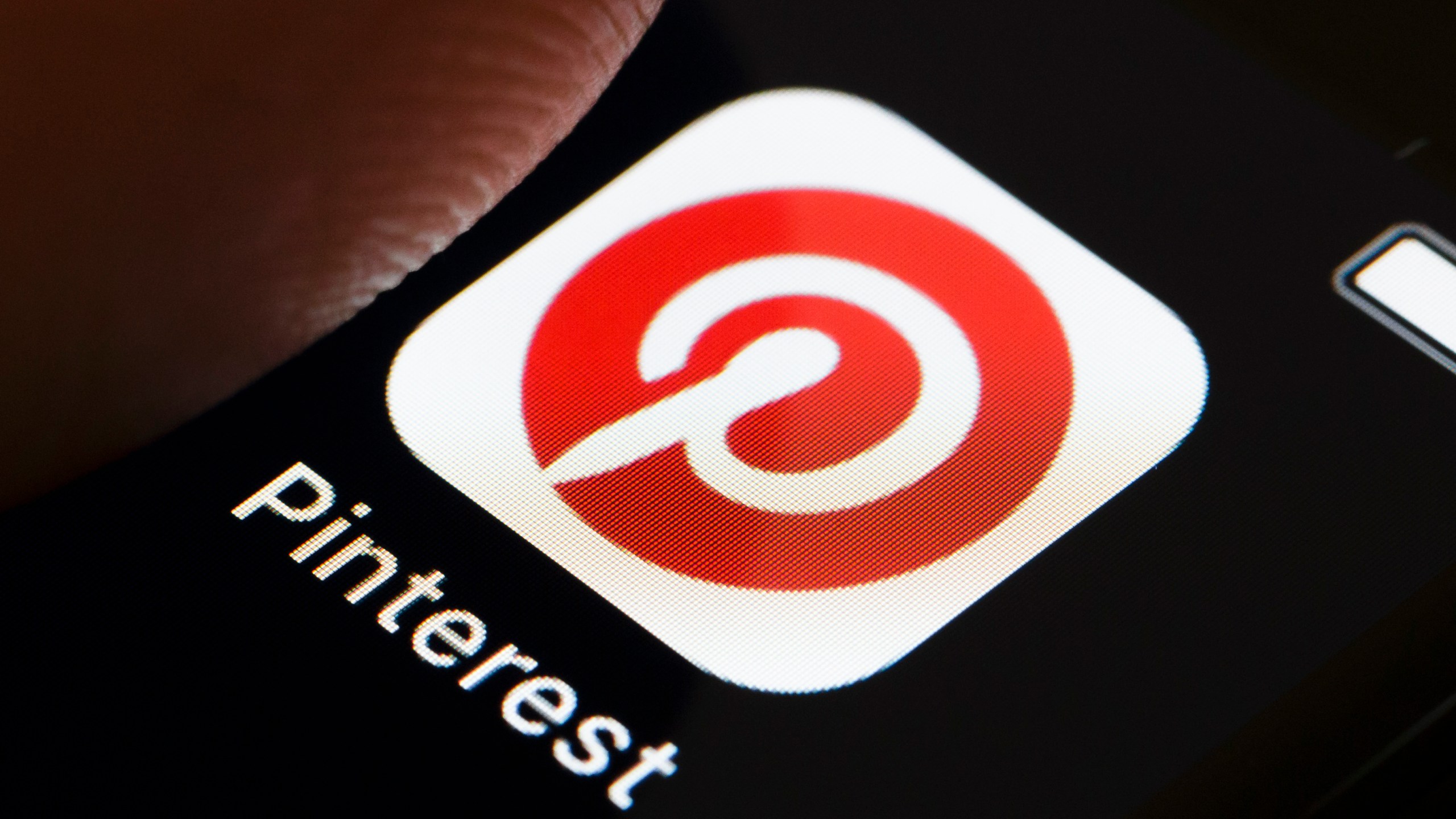 A photo illustration shows the PInterest app icon on a smartphone. (Credit: Thomas Trutschel/Photothek via Getty Images)