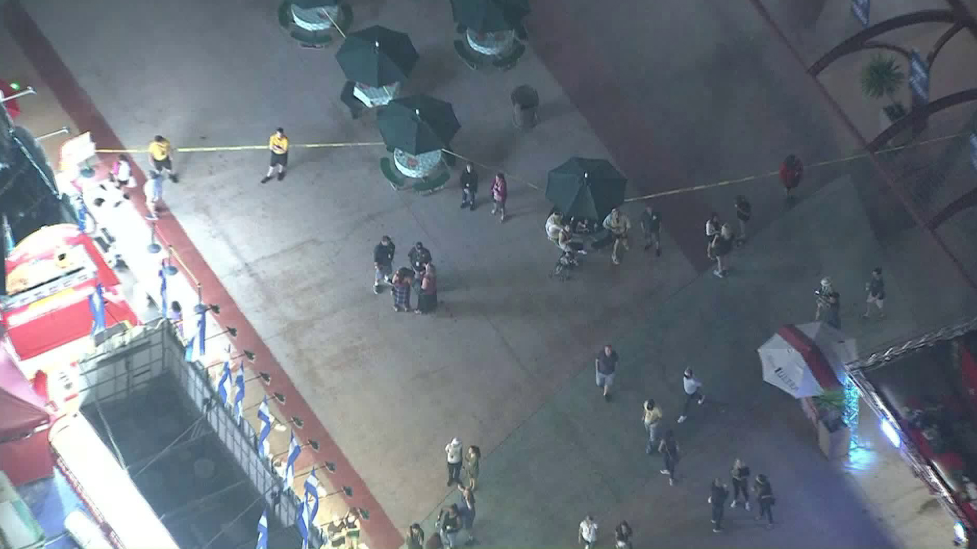 Security personnel and clusters of fairgoers gather around the scene of a fight at the Orange County Fair on July 31, 2019. (Credit: Sky5)