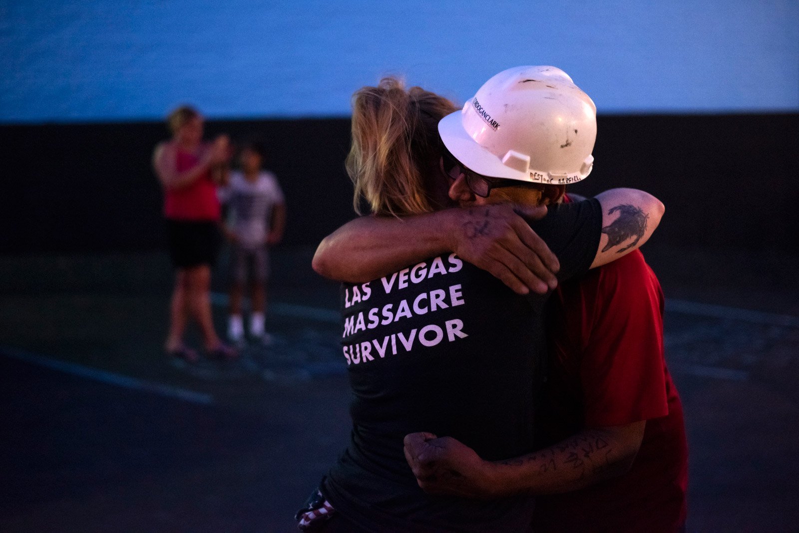 Greg Zanis embraces Leah Matthews, 33, of Cincinnati, who, as her shirt says, survived the 2017 mass shooting at a country music festival in Las Vegas. Zanis honored those victims with 58 crosses, which he placed in front of the iconic "Welcome to Fabulous Las Vegas" sign. Clark County, Nevada, officials declared November 12 "Greg Zanis Day" and presented the carpenter with a key to the Las Vegas Strip. (Credit: Mark Felix / CNN)