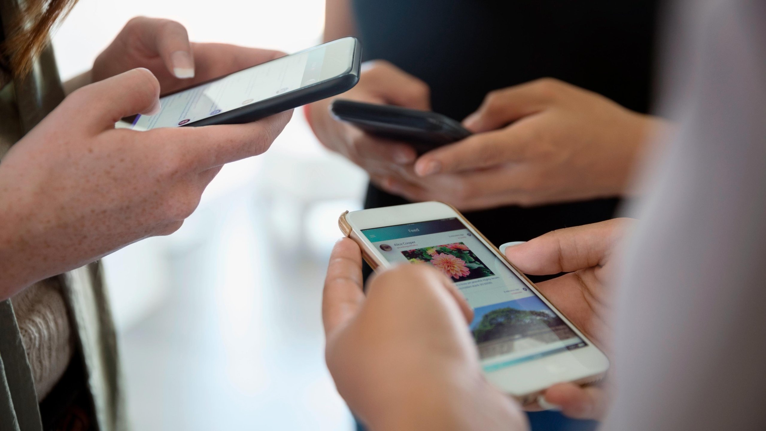 People are seen using smart phones in this undated photo. (Credit: Hero Images/ Getty Images via CNN)