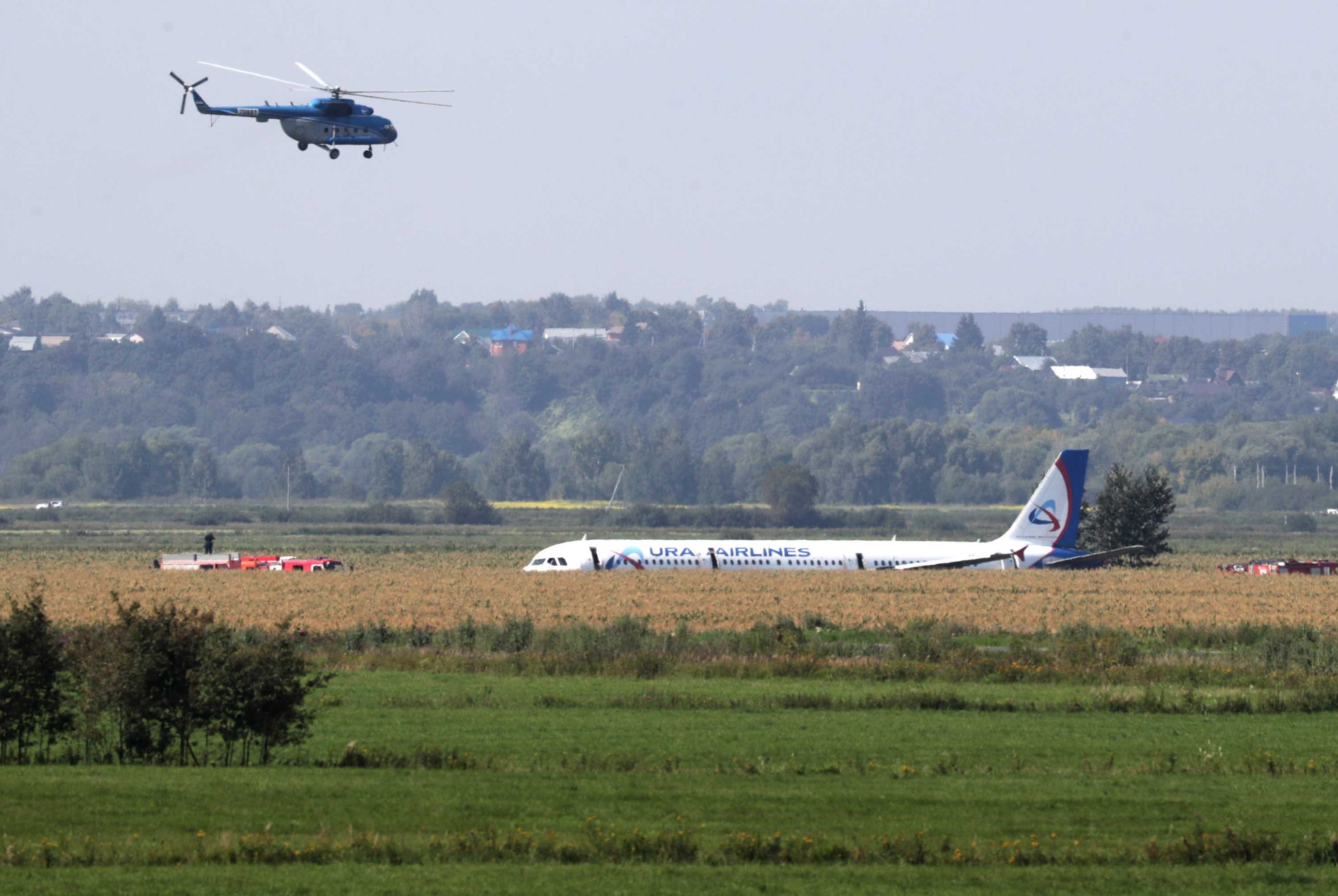 Emergency services assist at the sceneafter a plane crash-lands near Moscow, Russia, on Aug. 15, 2019. (Credit: Vyacheslav Prokofyev/TASS via Getty Images)