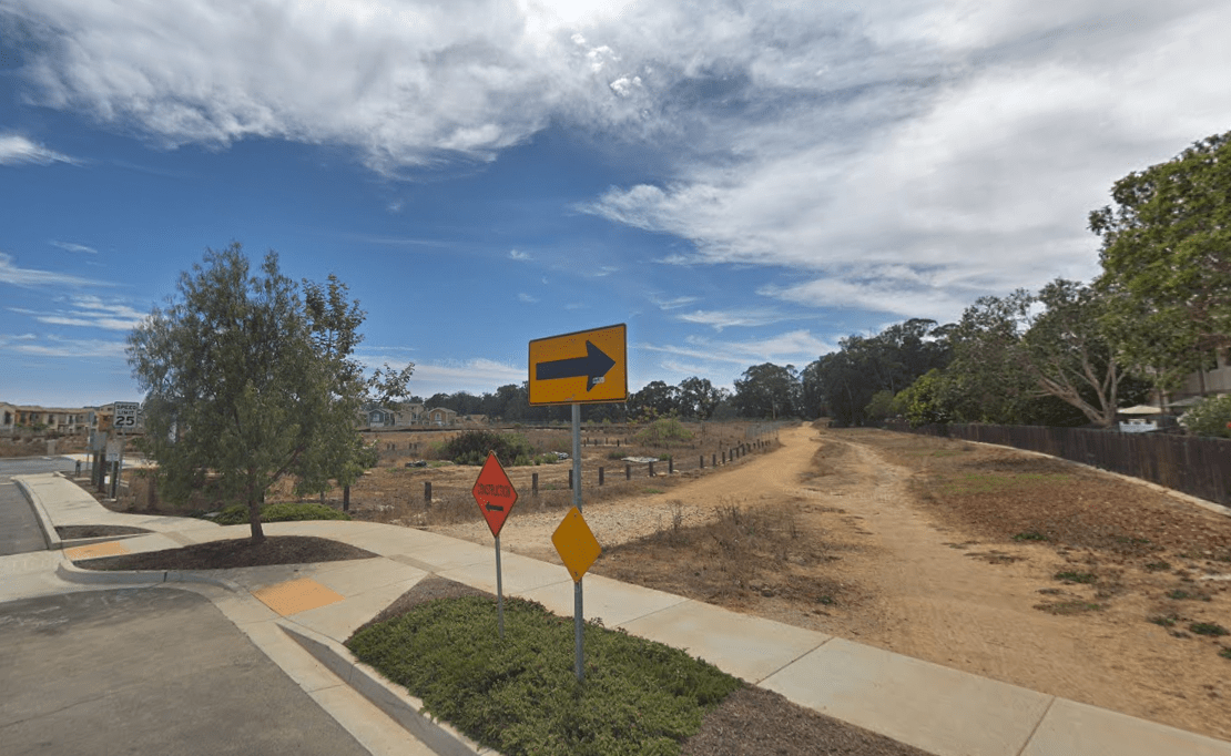 A dirt path near Phelps Road and Ocean Walk Lane is shown in a Street View image from Google Maps.