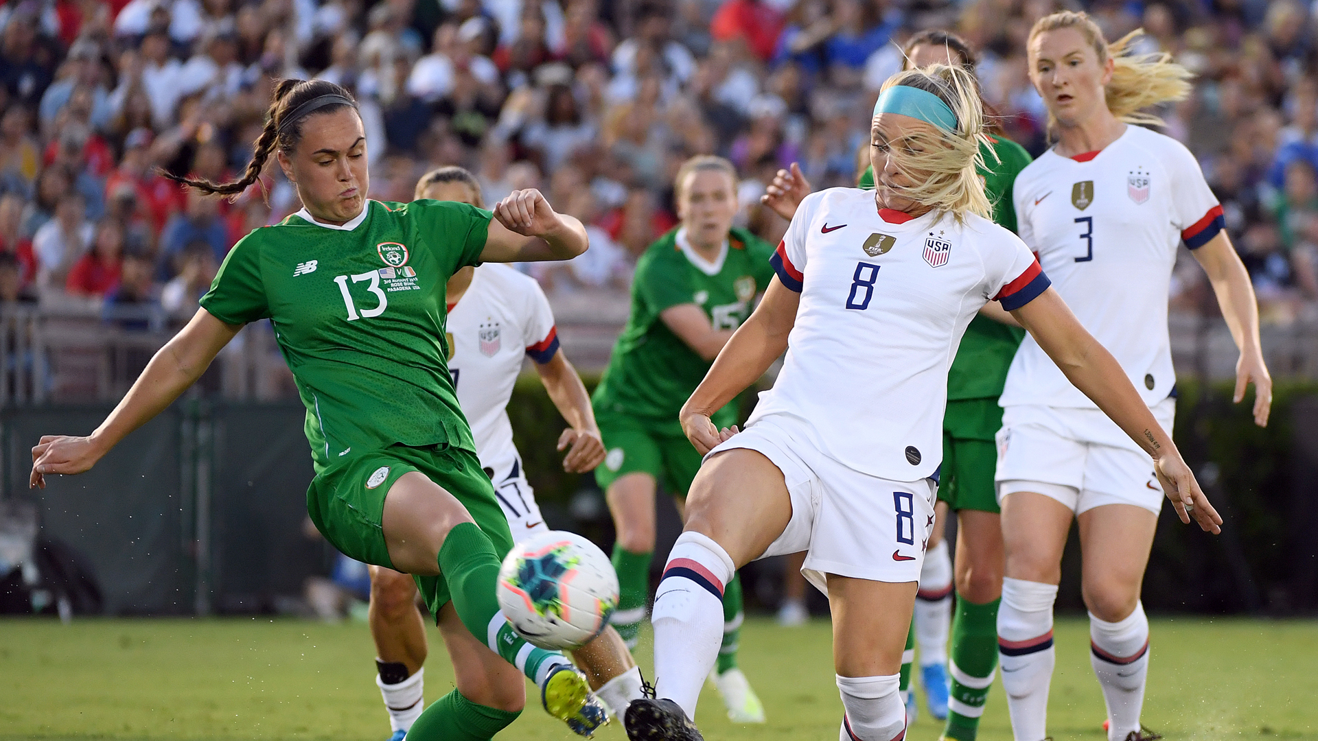 Julie Ertz #8 of the United States and Jess Gargan #13 of the Republic of Ireland go after a ball during the first half of the first game of the USWNT Victory Tour at Rose Bowl on August 03, 2019 in Pasadena, California. (Credit: Harry How/Getty Images)