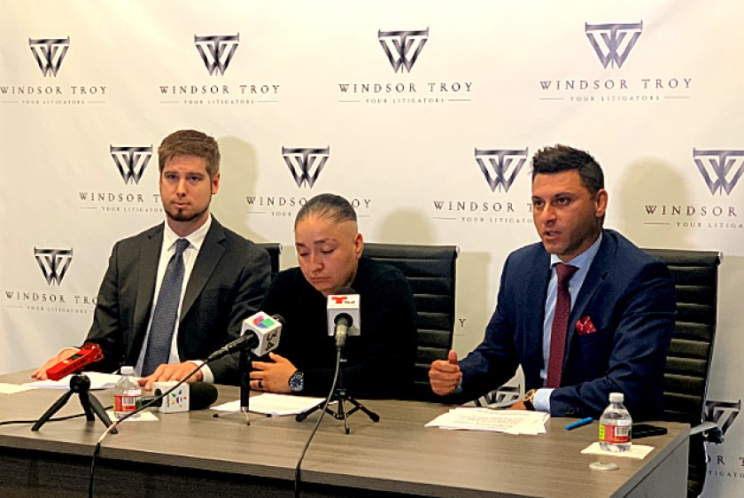 Valerie Arismendez, center, is flanked by attorneys Daniel Sharpe, left, and Shawn F. Matian at a news conference in Koreatown on Sept. 26, 2019, announcing a suit against the Los Angeles County Sheriff’s Department.(Credit: Windsor Troy law firm via Los Angeles Times)