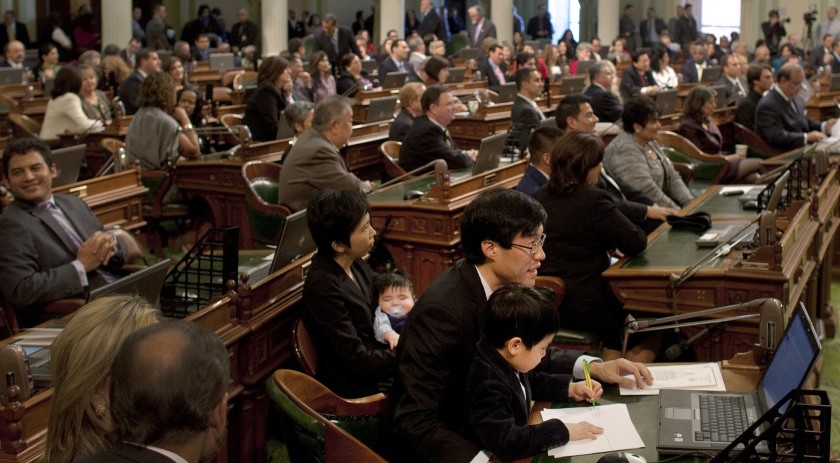 Sen. Richard Pan, then an assemblyman, holds his son William, 4, at the Capitol in Sacramento in 2010. (Credit: Gina Ferazzi / Los Angeles Times)