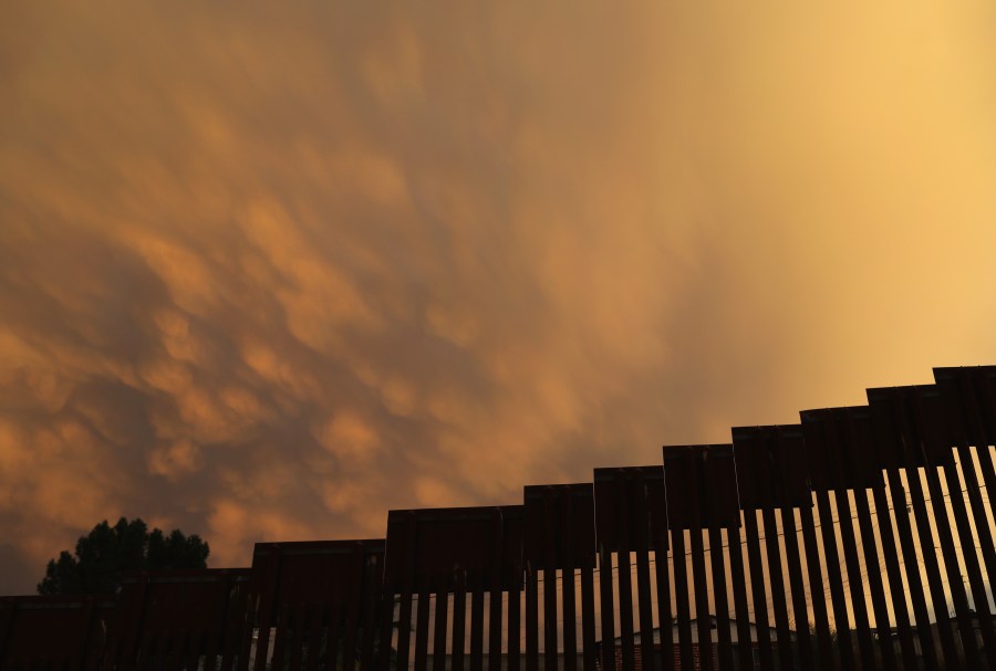 The U.S.-Mexico border fence is seen at sunset on July 22, 2018 in Nogales, Arizona. (Credit: John Moore/Getty Images)