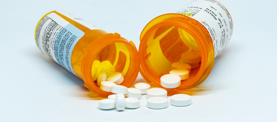 Pills spill out of two prescription bottles. (Getty Images)