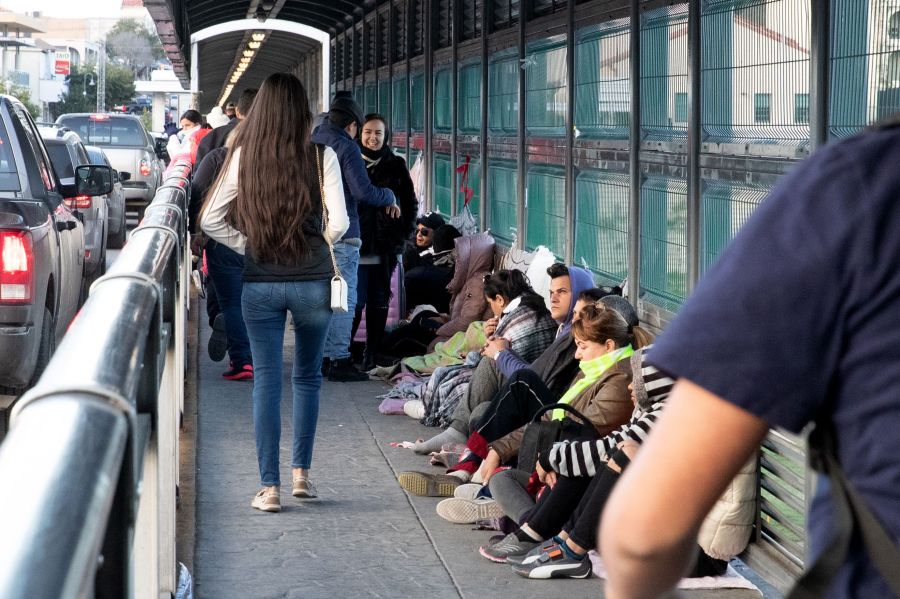 Asylum seekers await processing on the international bridge on the U.S.-Mexico border in Laredo, Texas, on Jan. 13, 2019. (Credit: Suzanne Cordeiro / AFP / Getty Images)